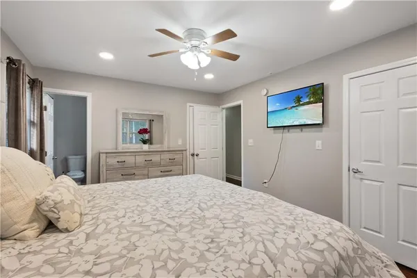 a bedroom with a large bed and a chandelier