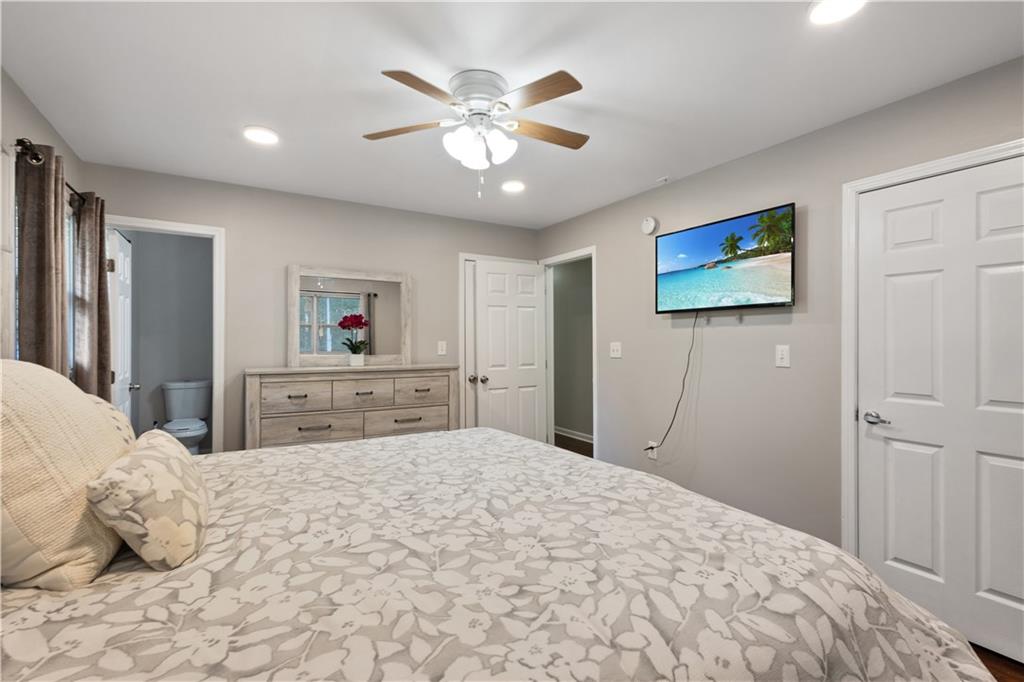 154 Dollar Mill Road Southwest Atlanta, GA 30331 - Photo 17 of 42 a bedroom with a large bed and a chandelier