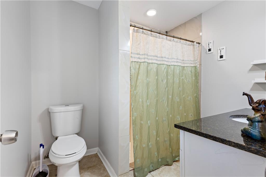 154 Dollar Mill Road Southwest Atlanta, GA 30331 - Photo 18 of 42 a bathroom with a granite countertop toilet and a sink