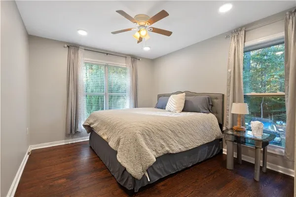 a bedroom with a bed and a large window