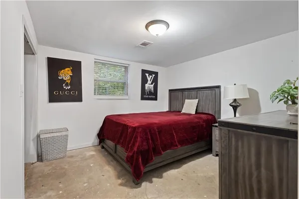 a spacious bedroom with a bed and a table in it