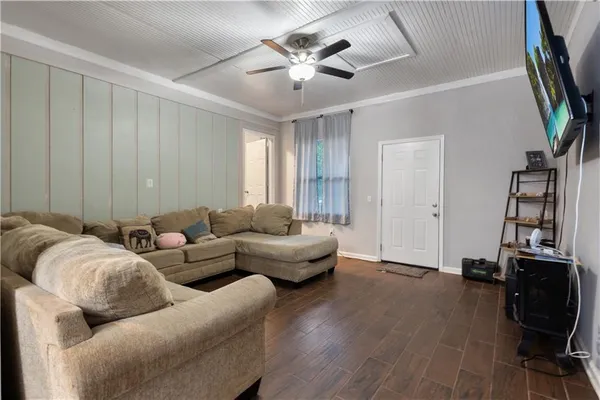 a living room with furniture and wooden floor