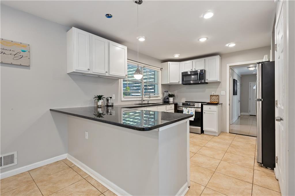 154 Dollar Mill Road Southwest Atlanta, GA 30331 - Photo 8 of 42 a kitchen with stainless steel appliances granite countertop a sink a stove a refrigerator and cabinets