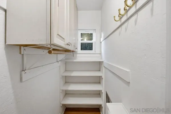 a view of staircase with white walls and window