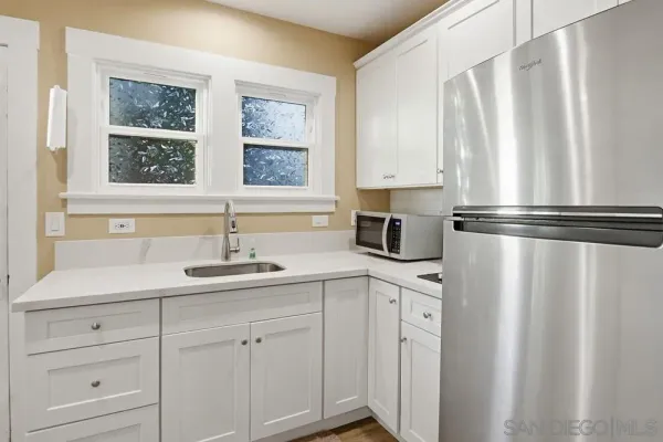 a kitchen with appliances cabinets and a sink