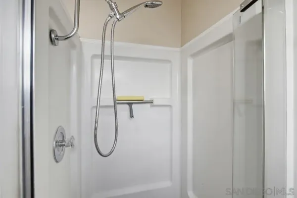 a bathroom with a glass shower door