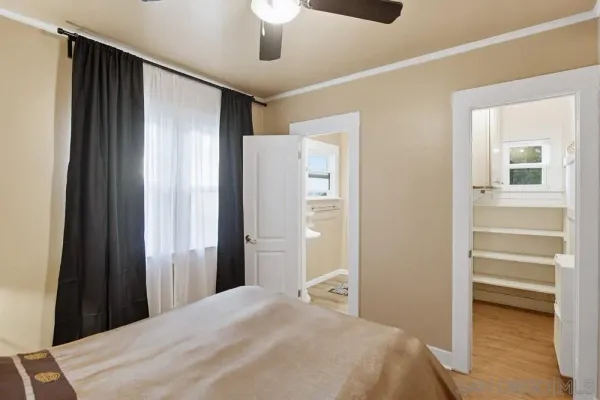 a bedroom with a bed and a walk in closet