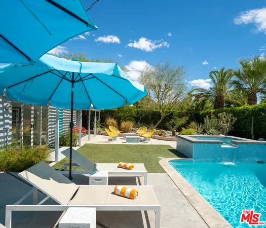 a view of a backyard with swimming pool