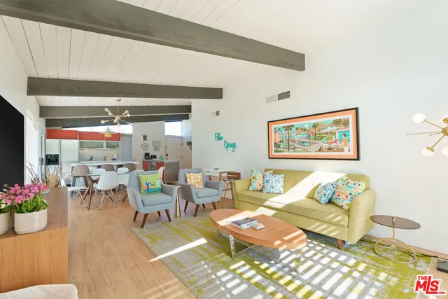 a living room with furniture and flowers