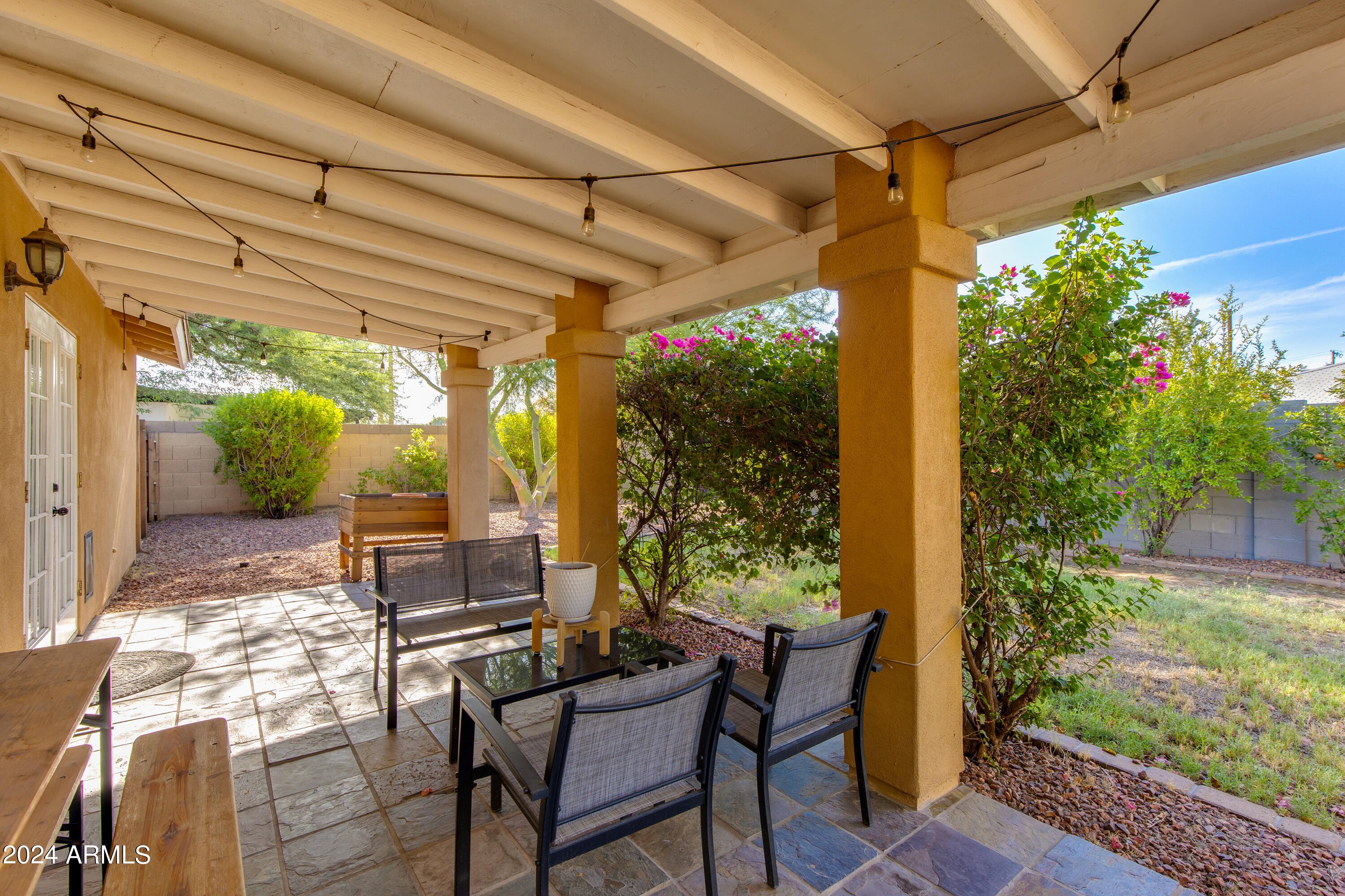 3041 East Roma Avenue Phoenix, AZ 85018 - Photo 13 of 14 a view of a patio with table and chairs and potted plants