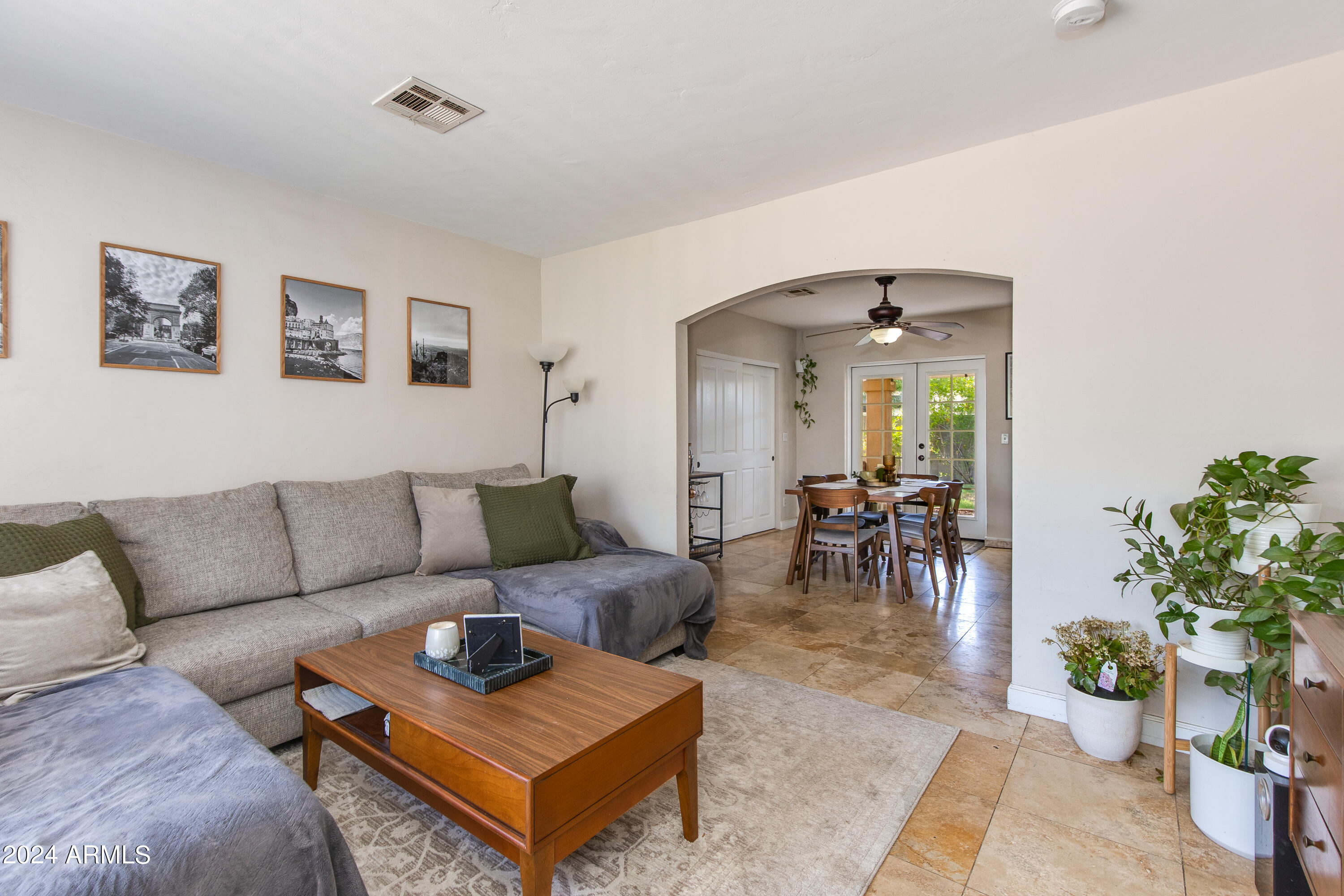 3041 East Roma Avenue Phoenix, AZ 85018 - Photo 3 of 14 a living room with furniture and a dining table with potted plants