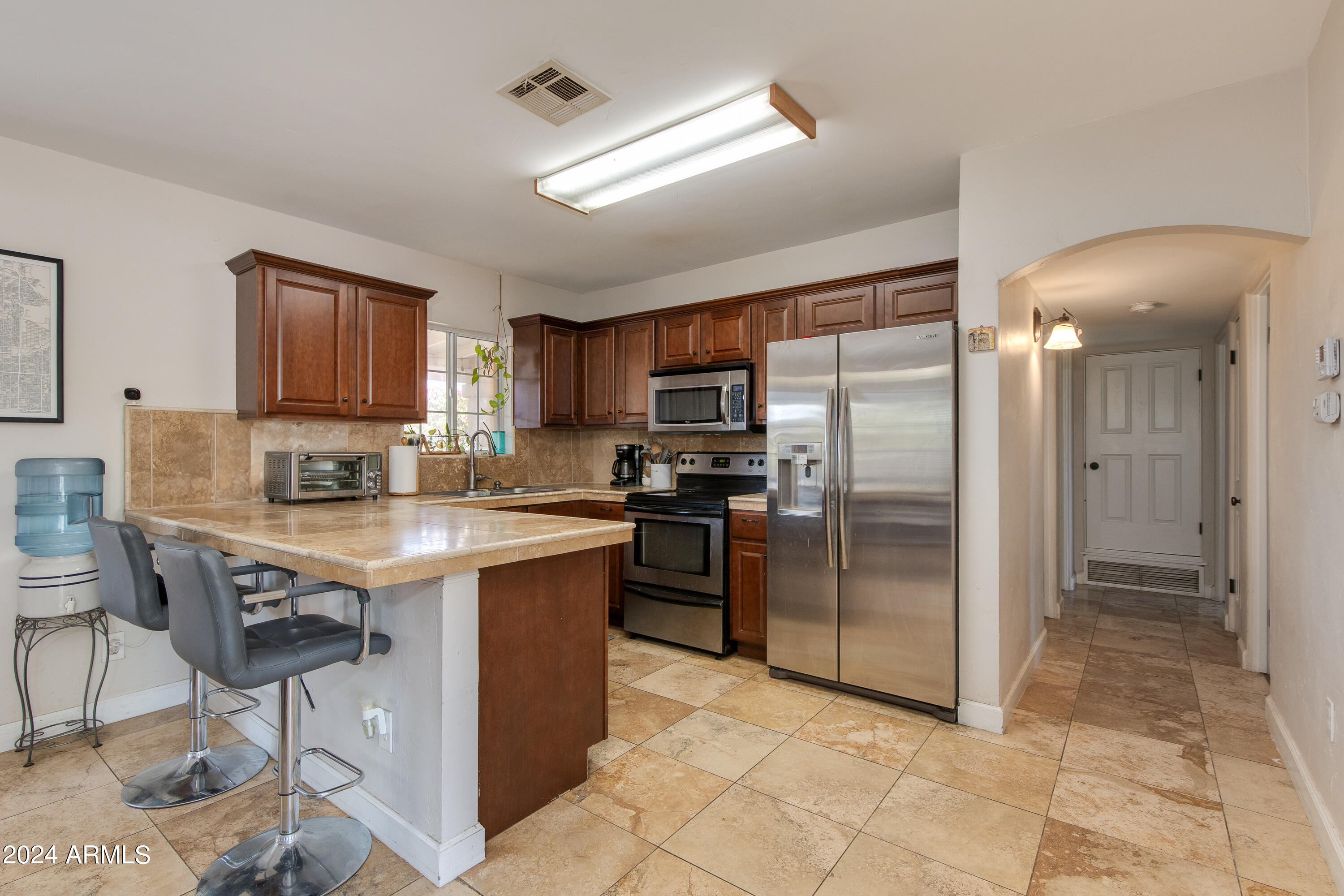 3041 East Roma Avenue Phoenix, AZ 85018 - Photo 5 of 14 a kitchen with stainless steel appliances granite countertop a refrigerator and a stove top oven