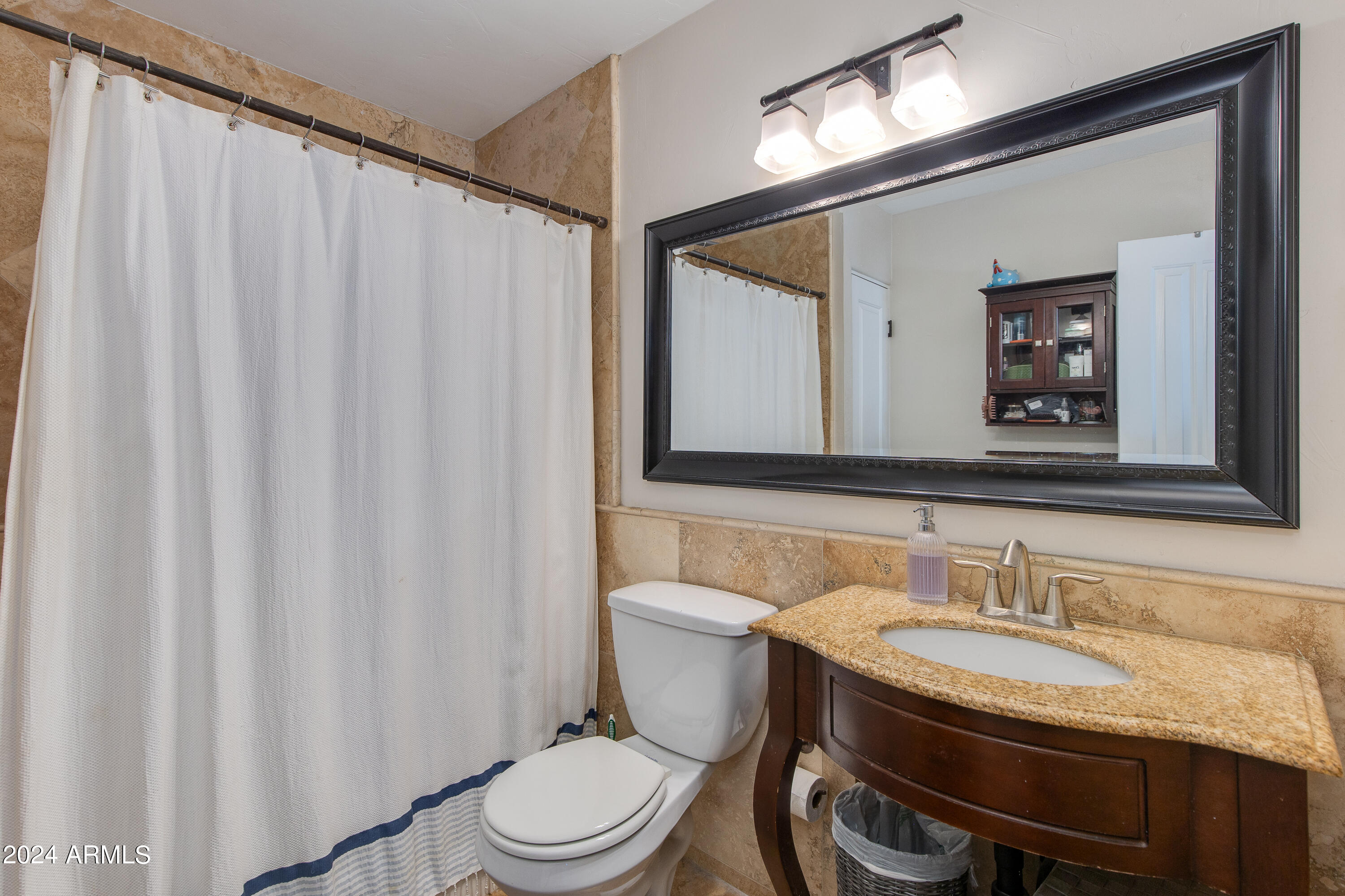 3041 East Roma Avenue Phoenix, AZ 85018 - Photo 8 of 14 a bathroom with a granite countertop toilet sink and mirror