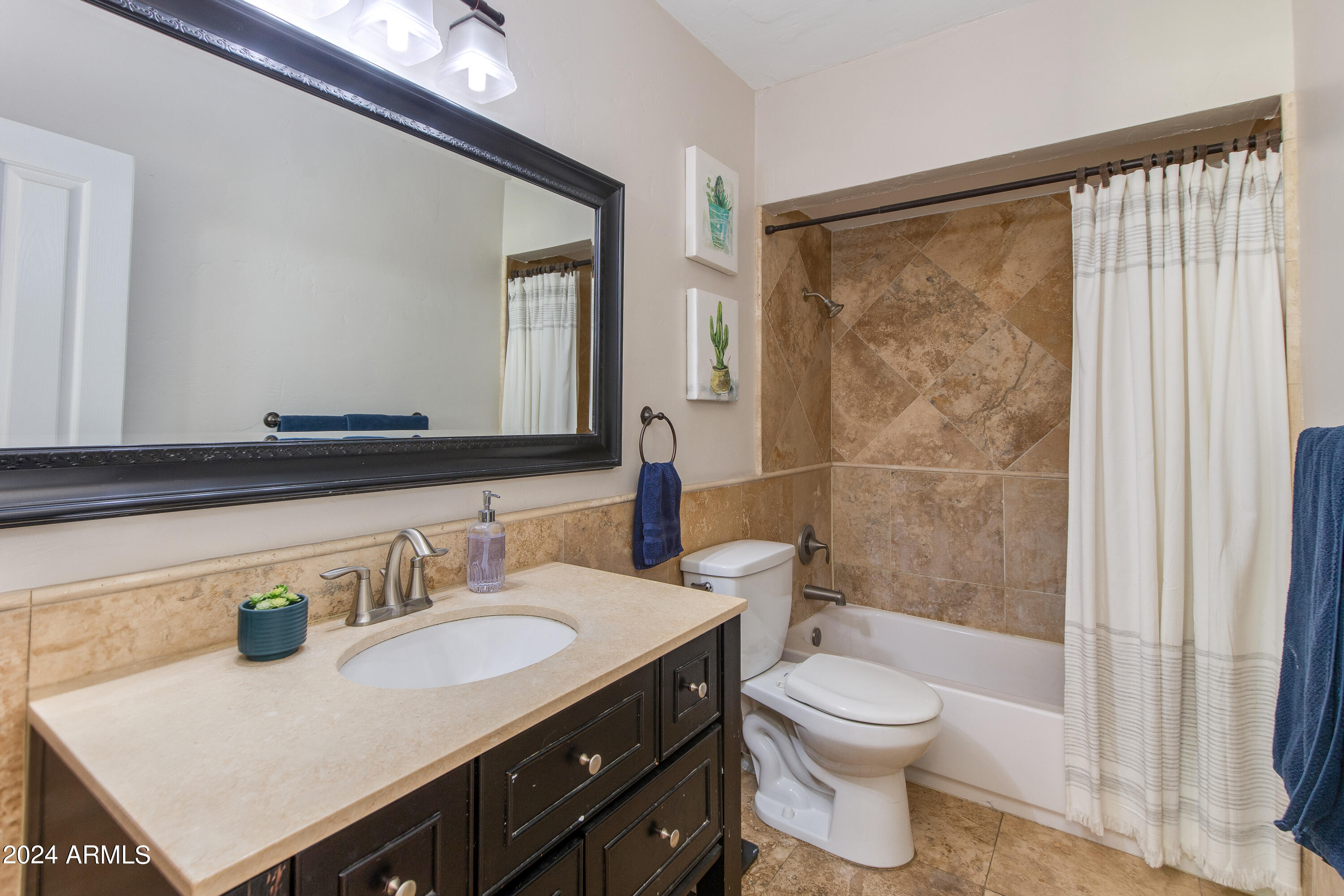 3041 East Roma Avenue Phoenix, AZ 85018 - Photo 10 of 14 a bathroom with a sink a toilet and shower