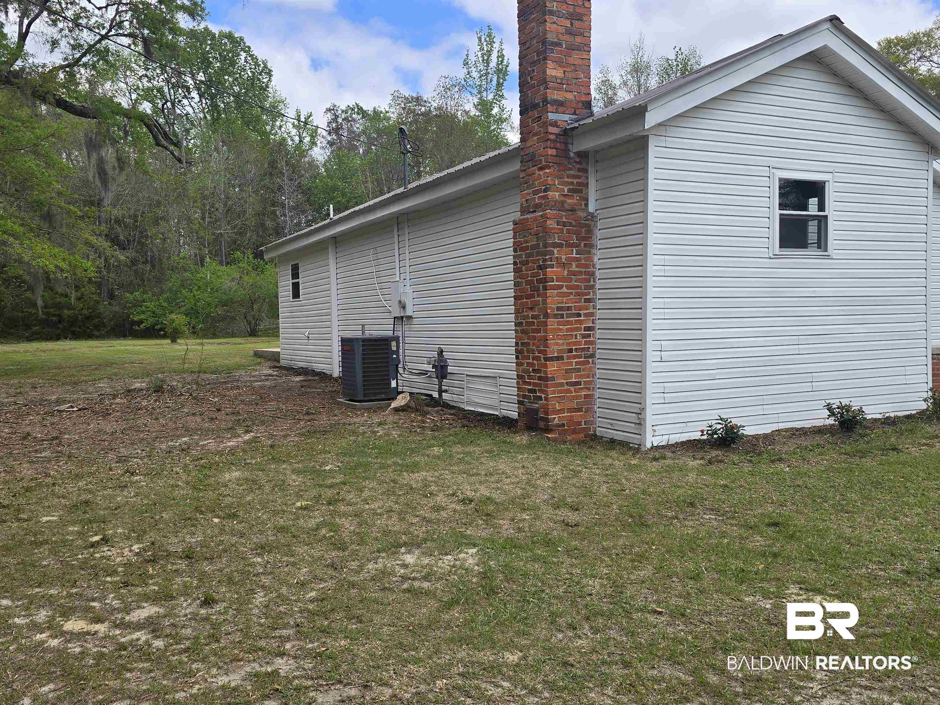 821 Dailey Street Brewton, AL 36426 - Photo 7 of 17 View of side of home with a lawn and a chimney