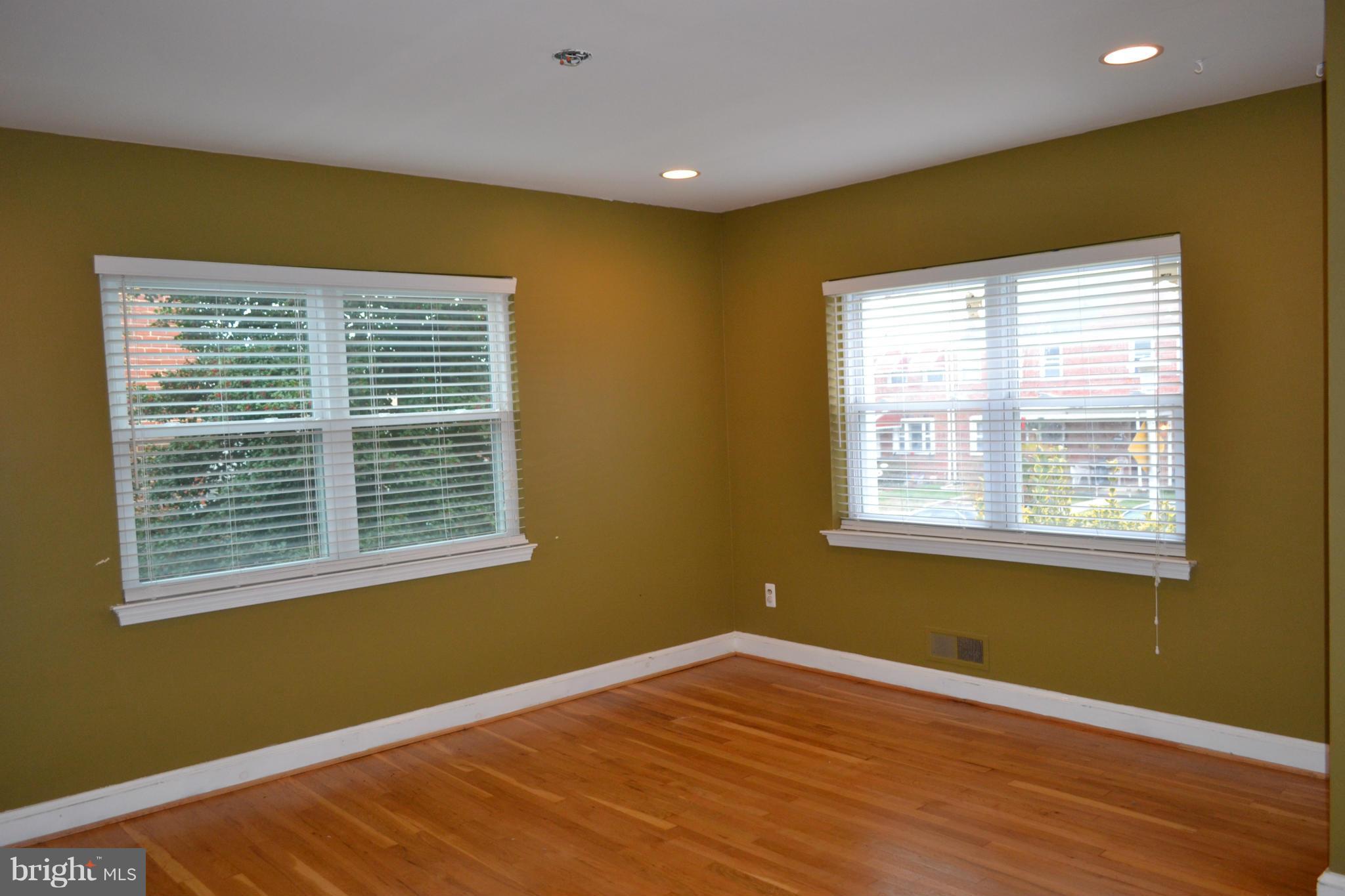 842 Bradhurst Road Baltimore, MD 21212 - Photo 11 of 28 a view of an empty room with wooden floor and a window