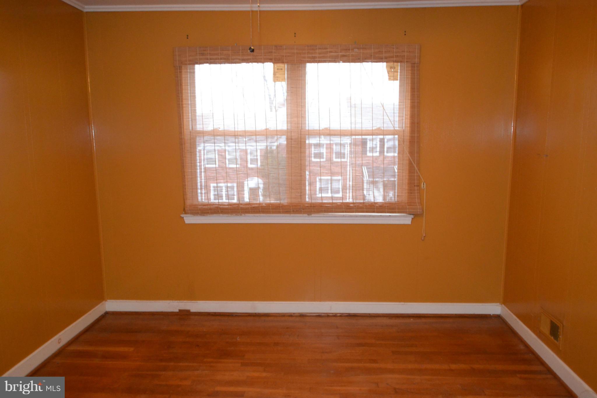 842 Bradhurst Road Baltimore, MD 21212 - Photo 18 of 28 an empty room with wooden floor and windows