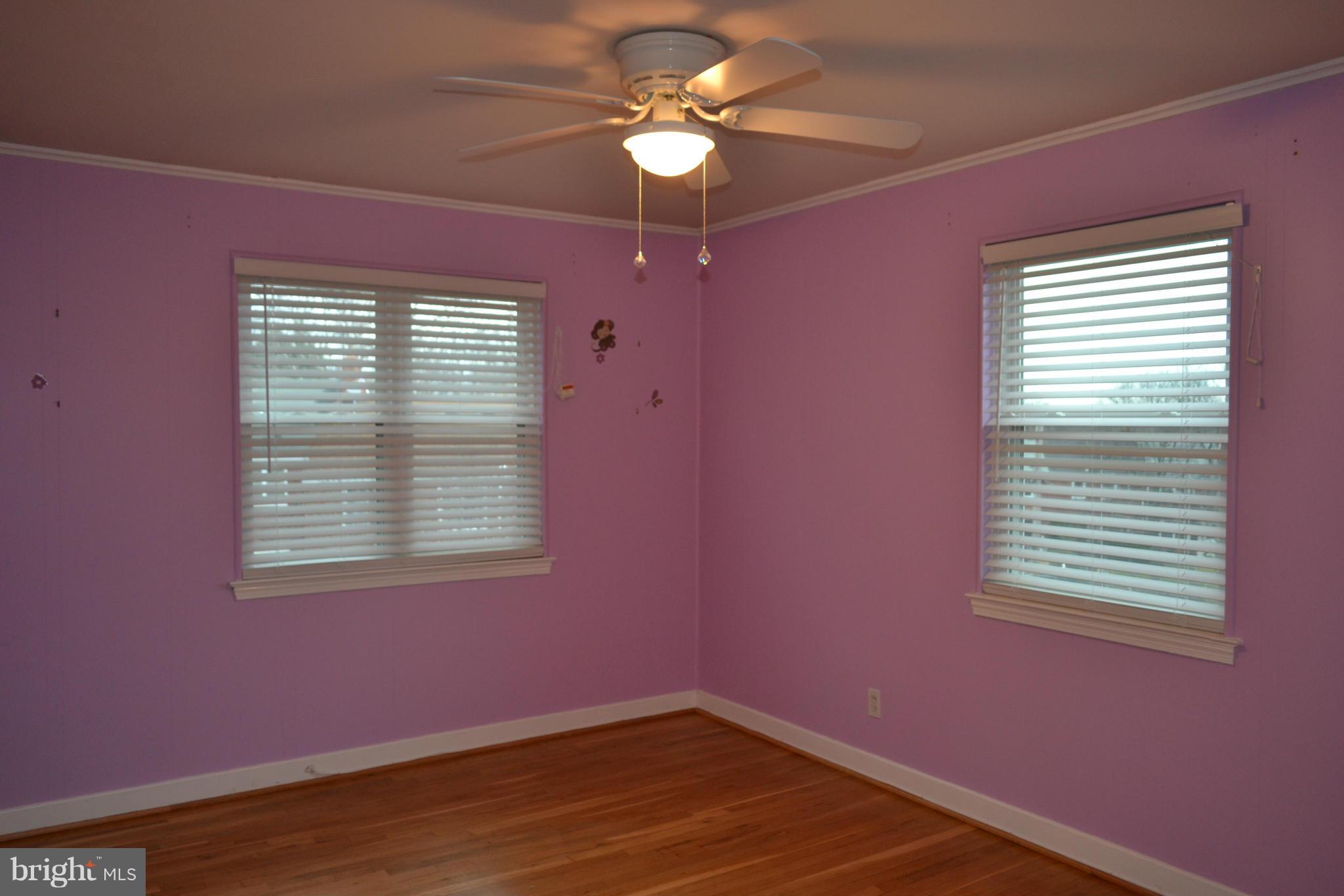 842 Bradhurst Road Baltimore, MD 21212 - Photo 21 of 28 a big room with wooden floor a chandelier fan and windows