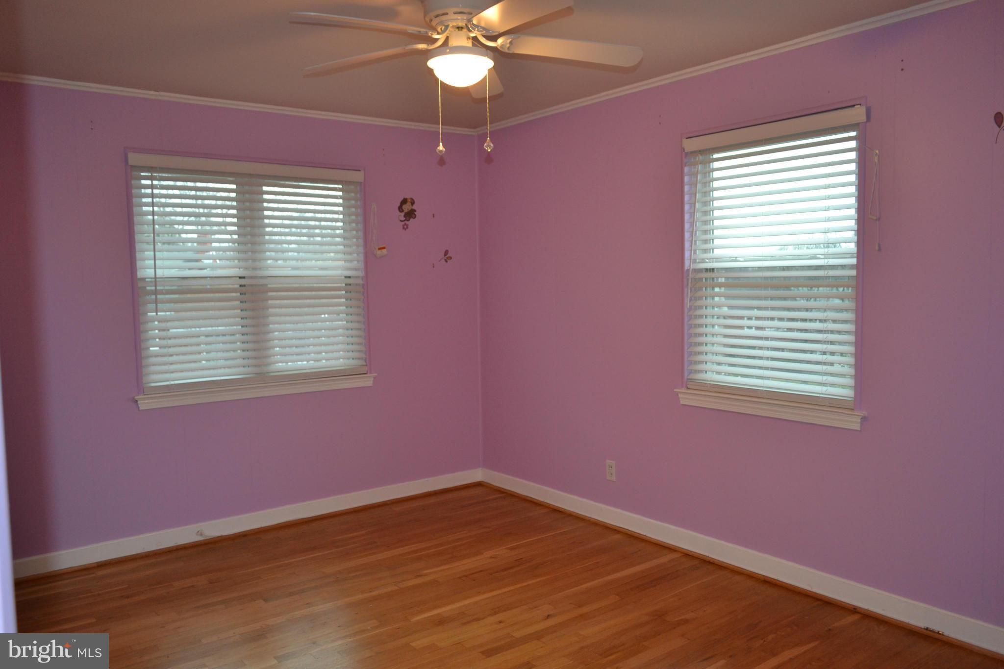 842 Bradhurst Road Baltimore, MD 21212 - Photo 22 of 28 a view of an empty room with a window and wooden floor