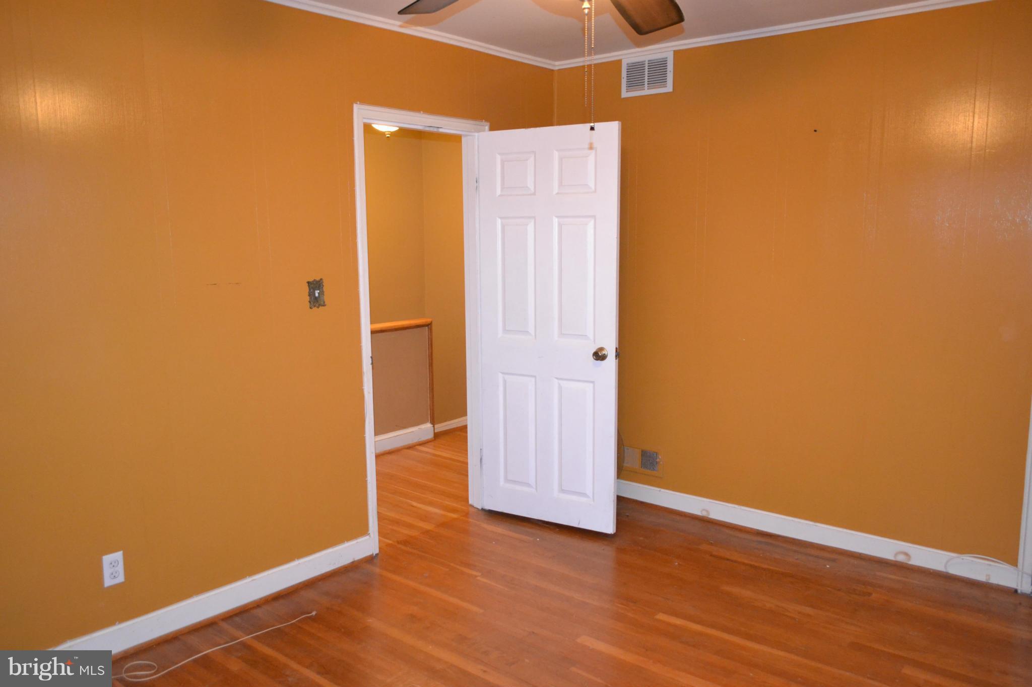 842 Bradhurst Road Baltimore, MD 21212 - Photo 23 of 28 an empty room with wooden floor and windows