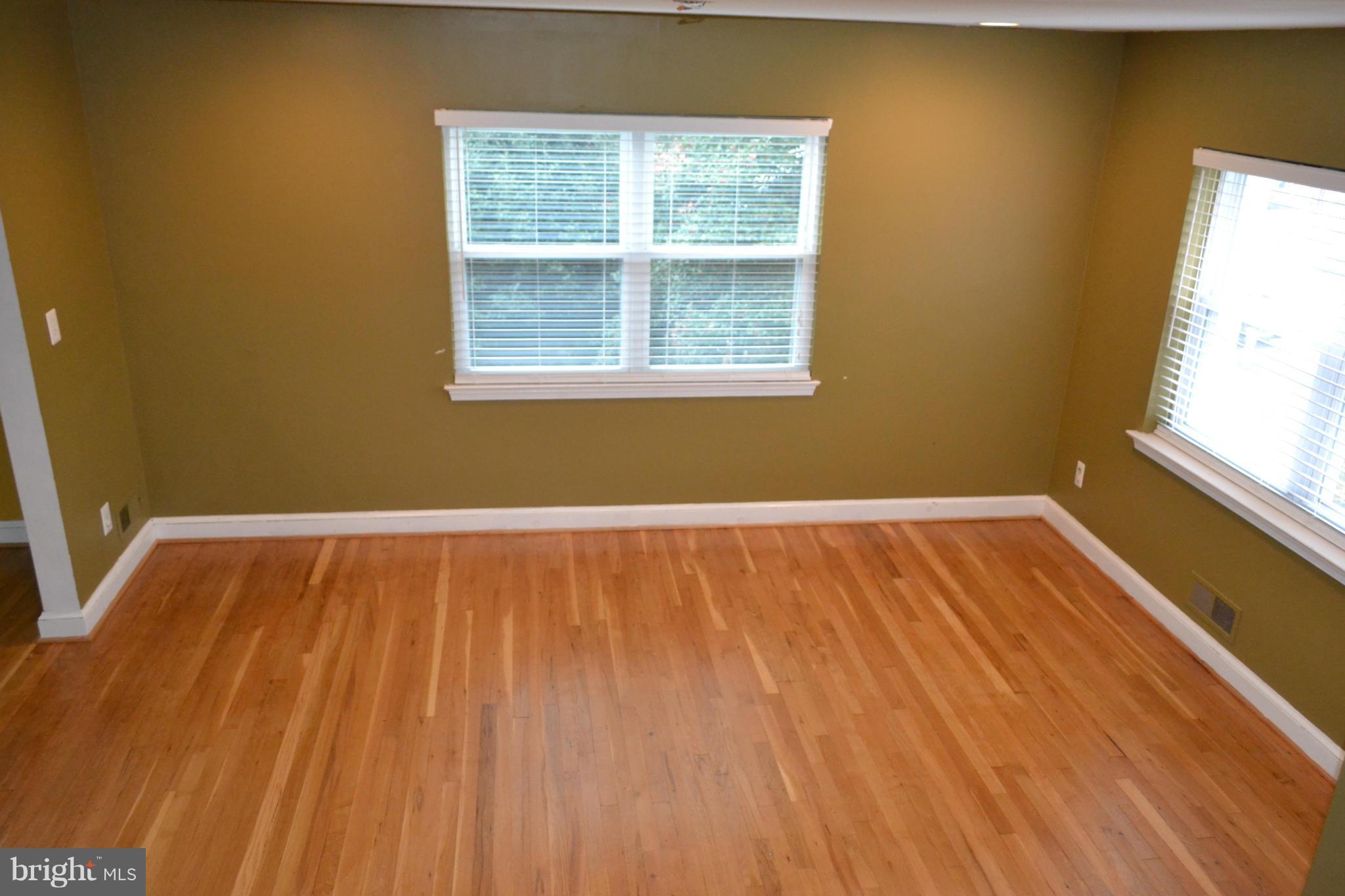 842 Bradhurst Road Baltimore, MD 21212 - Photo 24 of 28 a view of an empty room with wooden floor and a window