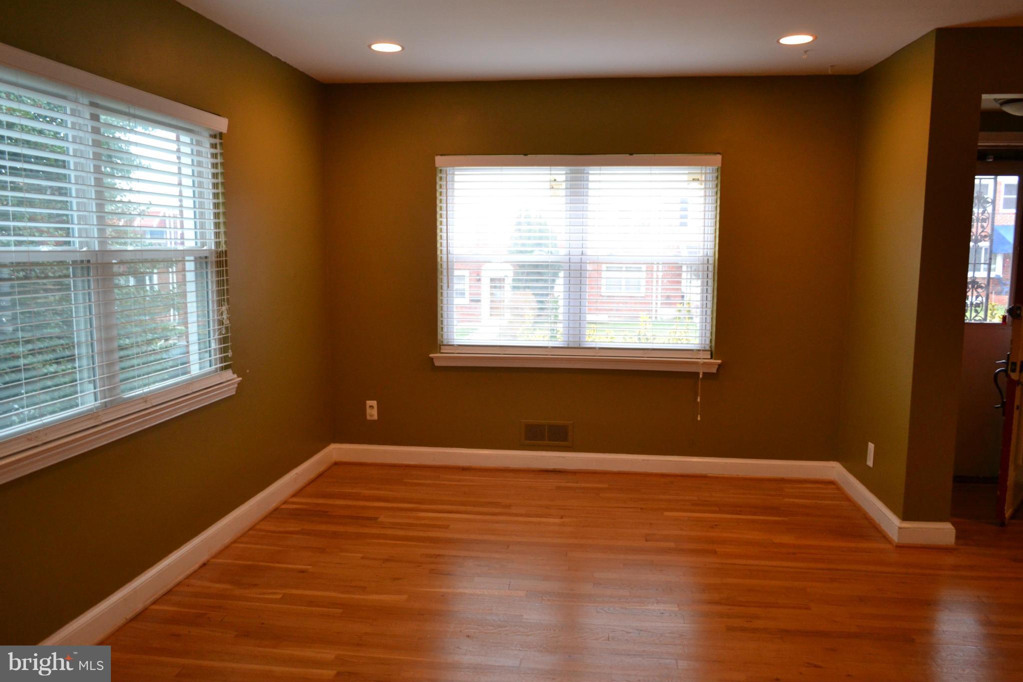 842 Bradhurst Road Baltimore, MD 21212 - Photo 6 of 28 a view of an empty room with wooden floor and a window