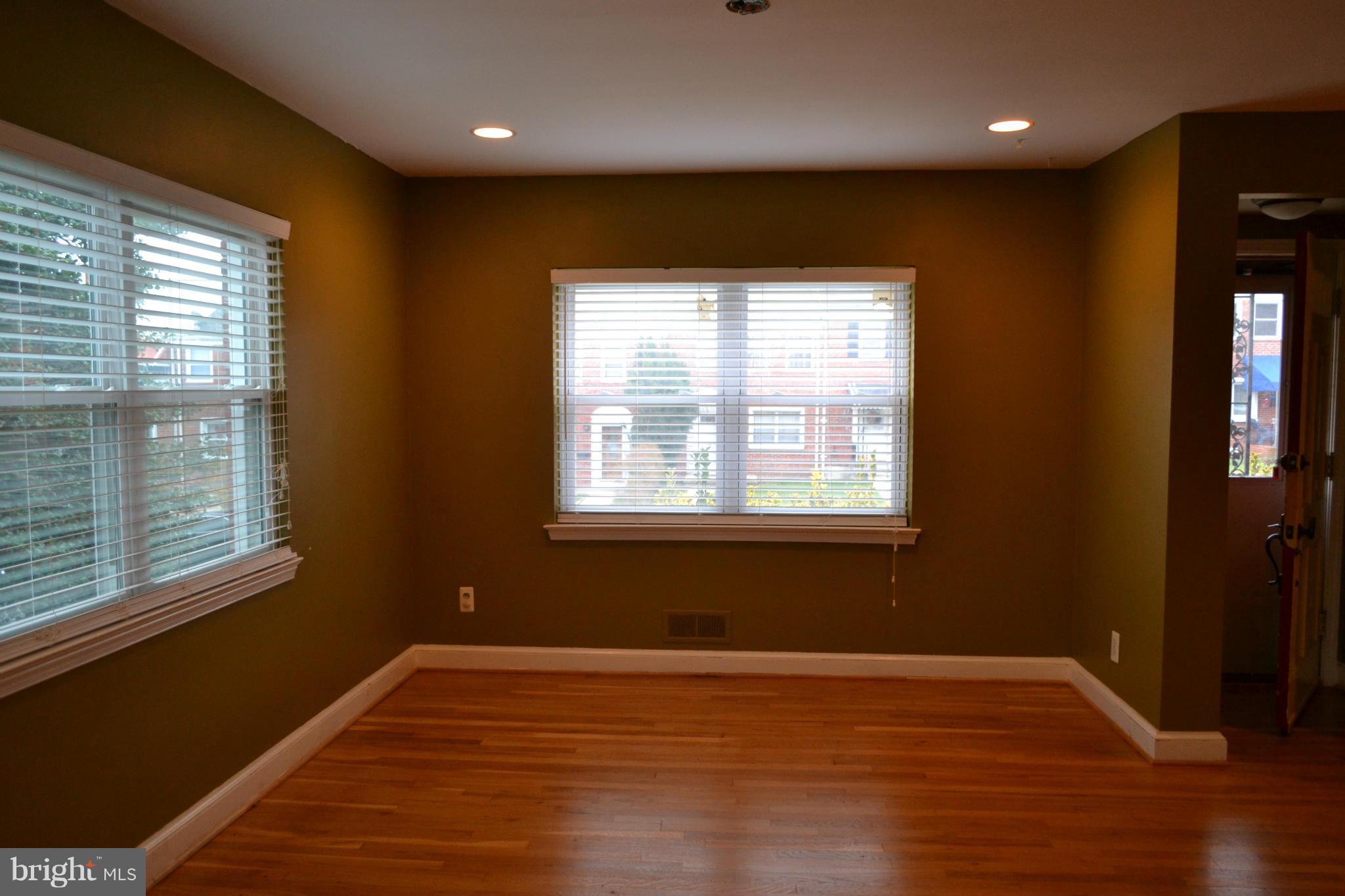 842 Bradhurst Road Baltimore, MD 21212 - Photo 7 of 28 a view of an empty room with wooden floor and a window