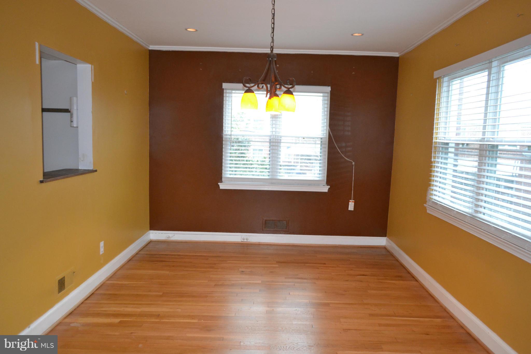 842 Bradhurst Road Baltimore, MD 21212 - Photo 10 of 28 a view of an empty room with wooden floor and a window