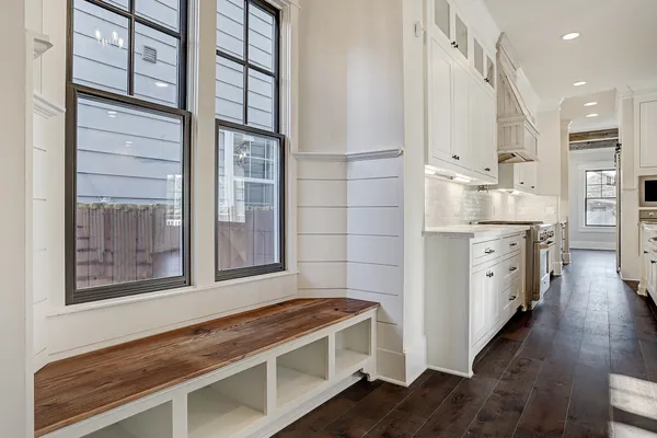 a kitchen with stainless steel appliances kitchen island granite countertop a sink a stove and cabinets