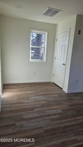 a bathroom with a toilet a sink a vanity and mirror