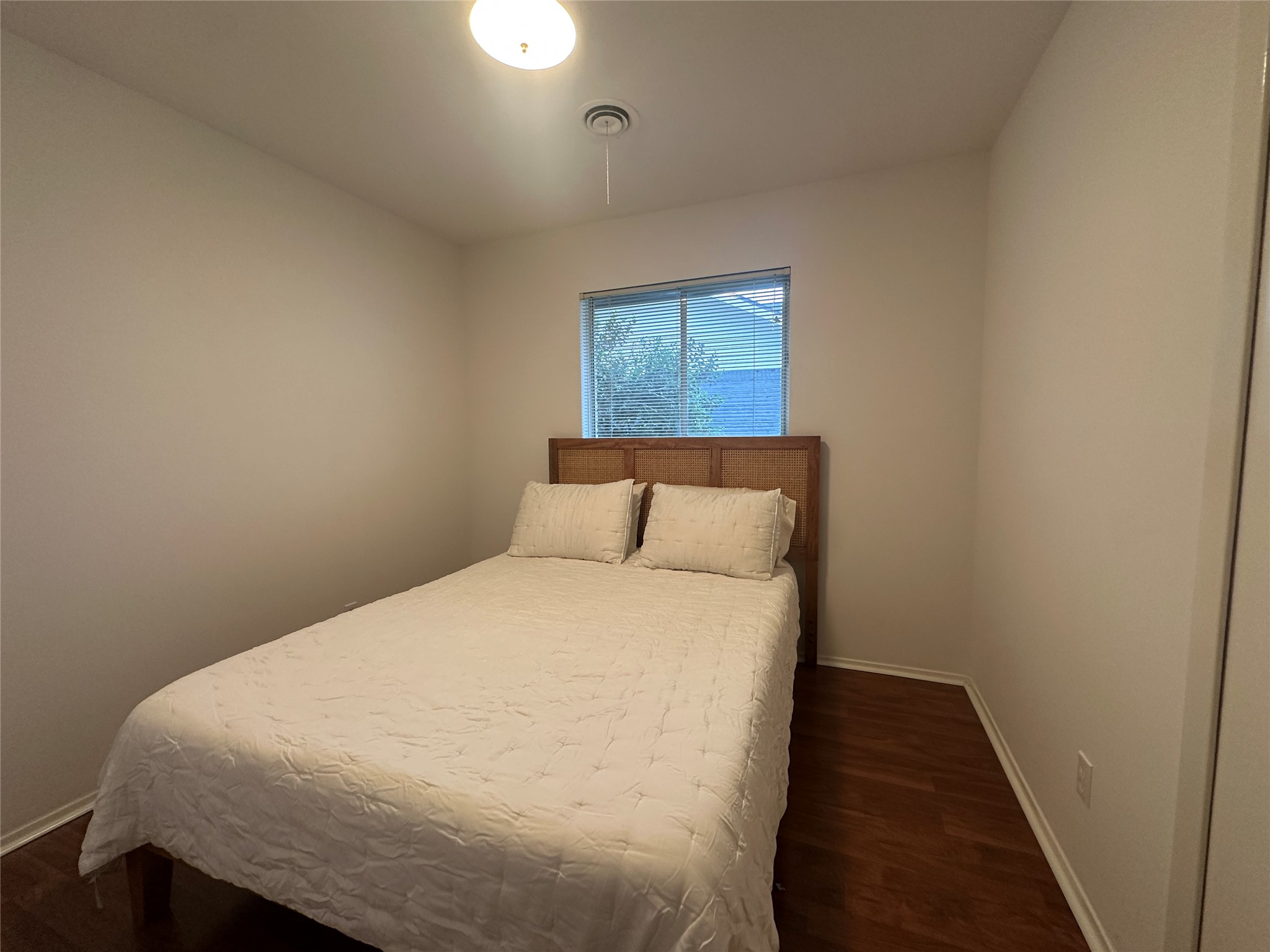 1908 Pompton Drive Austin, TX 78757 - Photo 11 of 22 a bedroom with a bed and wooden floor