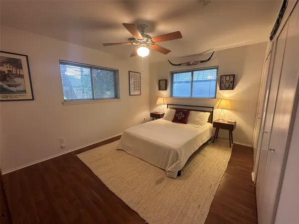 a bedroom with a large bed and a ceiling fan