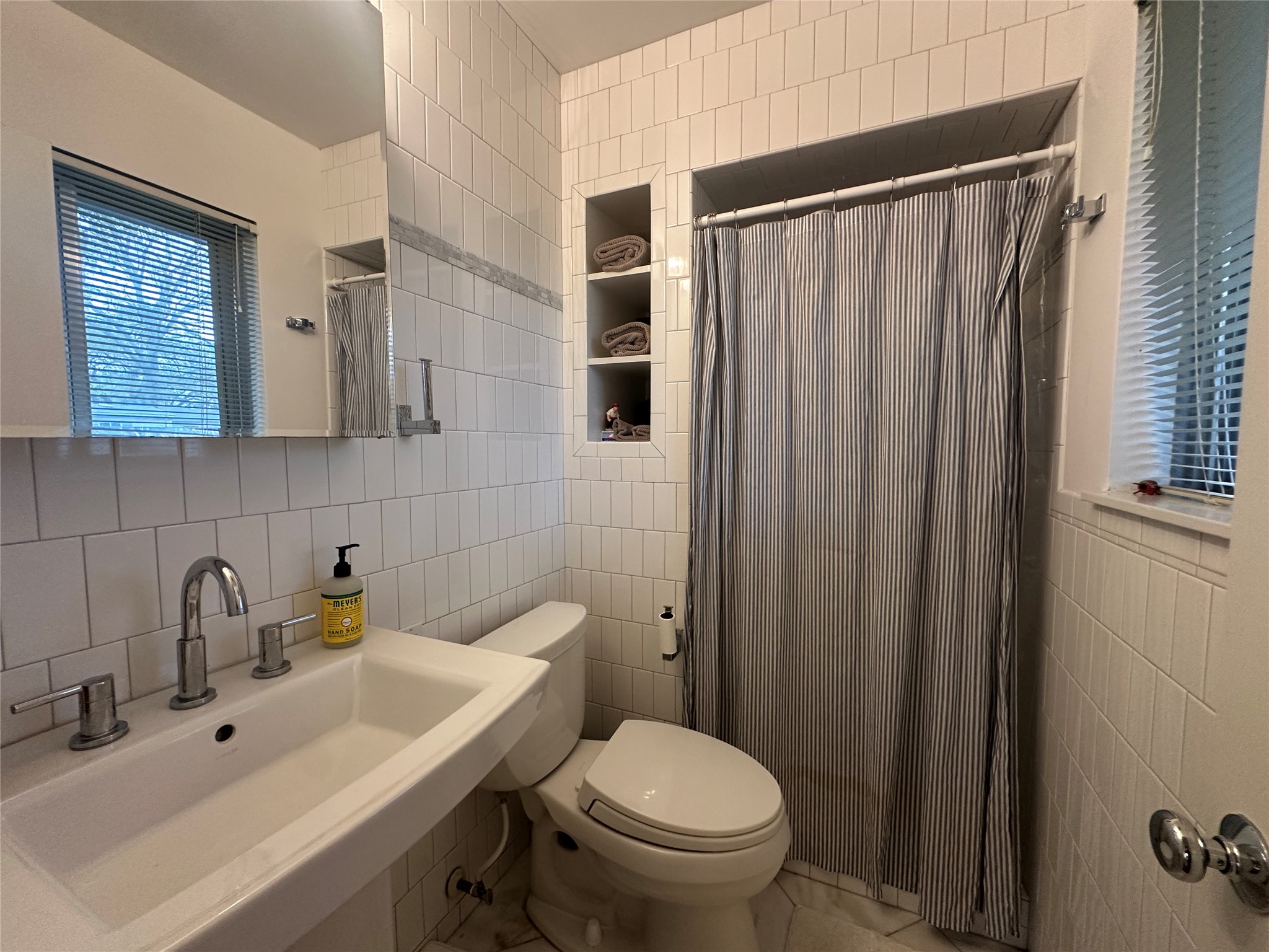 1908 Pompton Drive Austin, TX 78757 - Photo 15 of 22 a bathroom with a sink a toilet and shower curtain