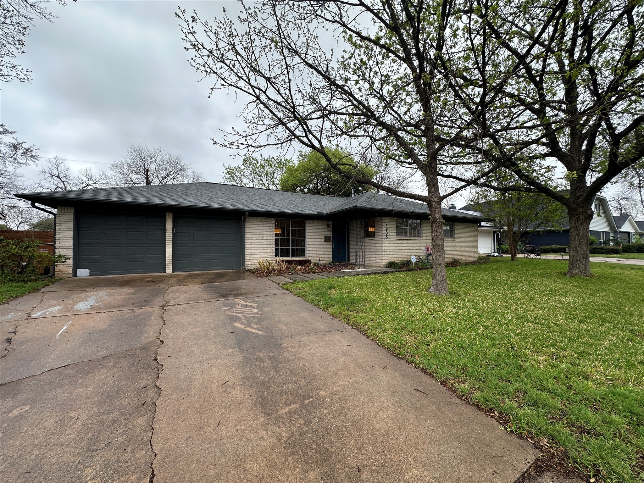1908 Pompton Drive Austin, TX 78757 - Photo 20 of 22 a front view of a house with a garden and yard