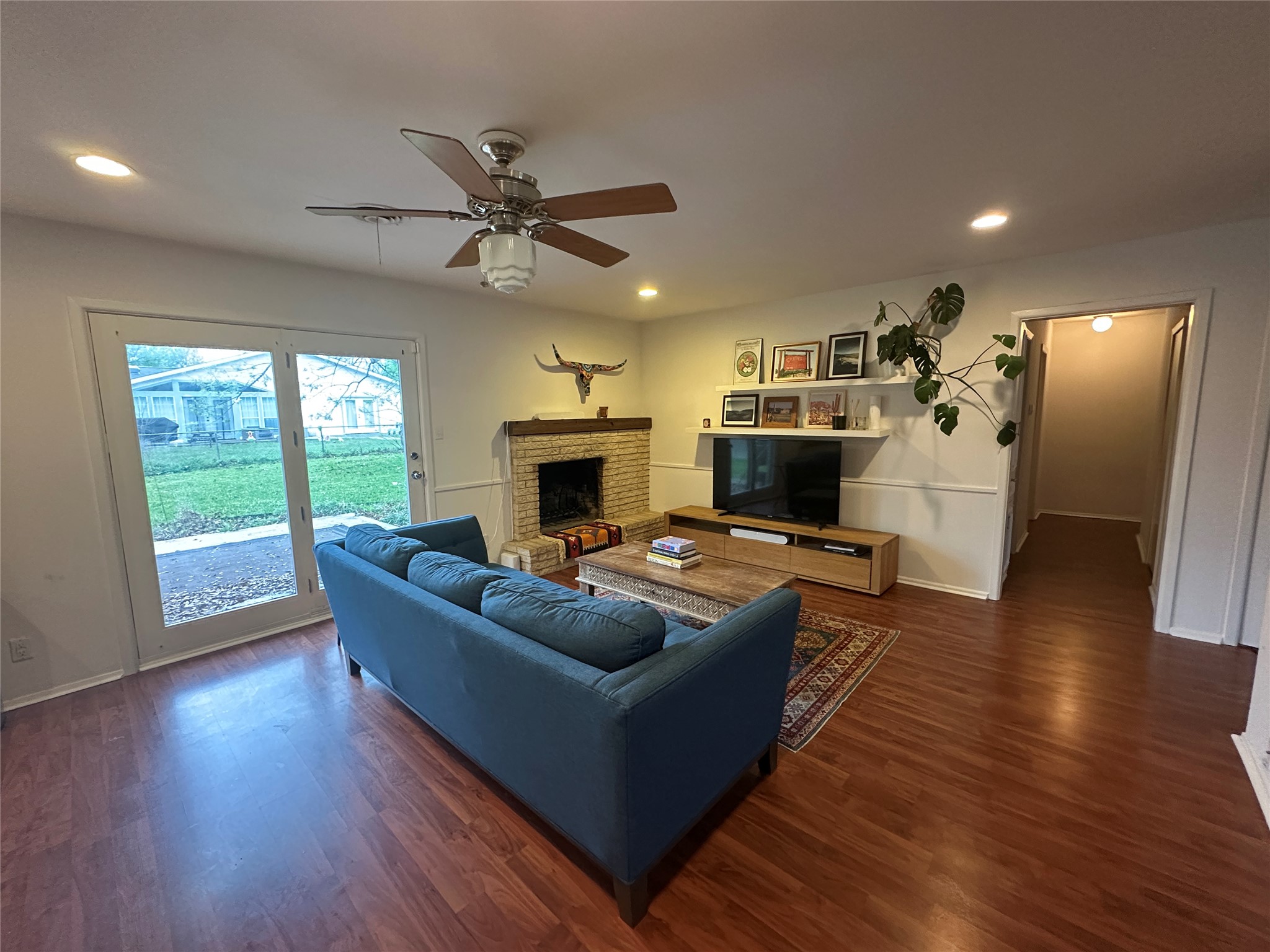1908 Pompton Drive Austin, TX 78757 - Photo 2 of 22 a living room with furniture a flat screen tv and a fireplace