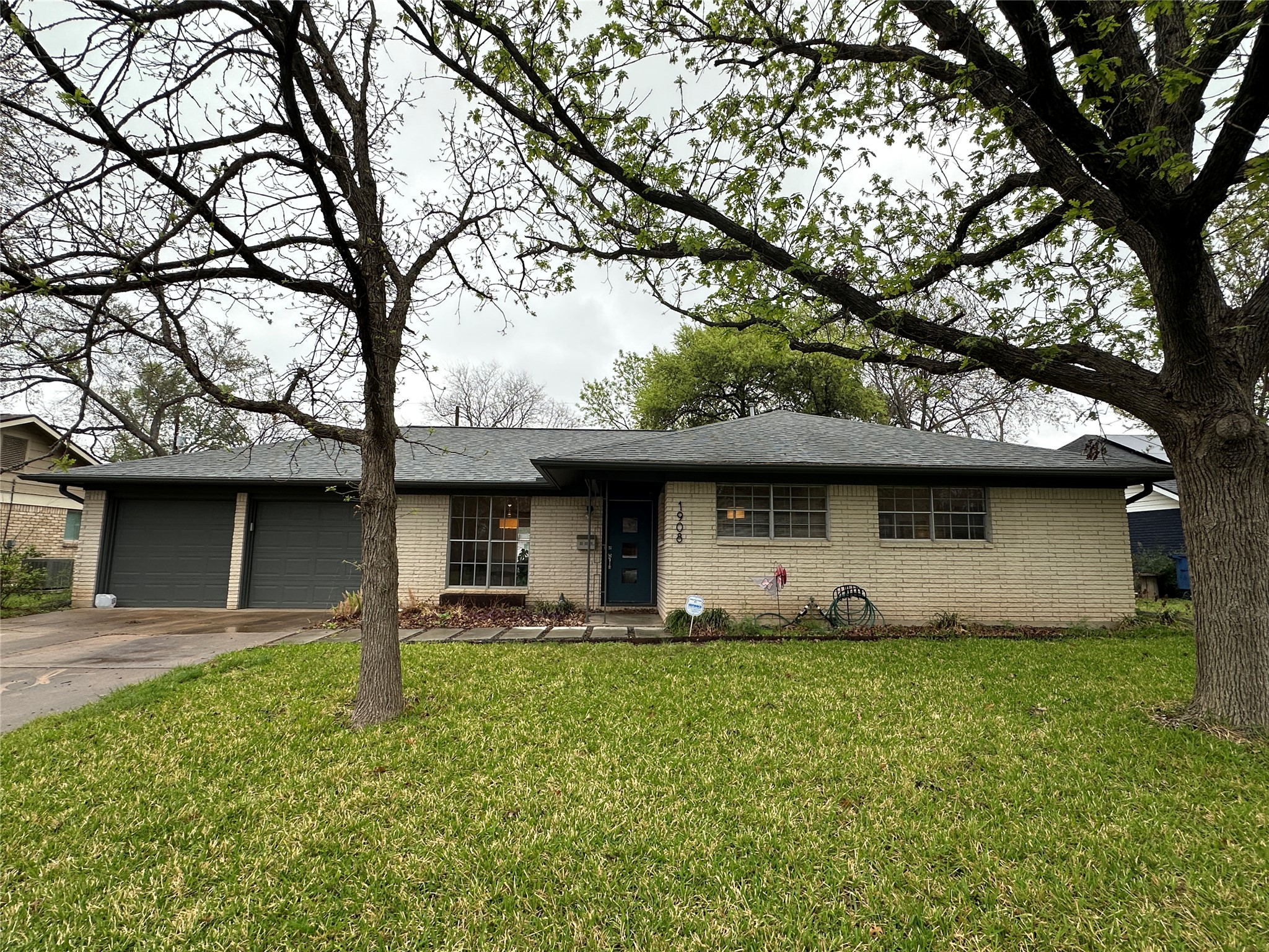 1908 Pompton Drive Austin, TX 78757 - Photo 21 of 22 a front view of a house with a garden