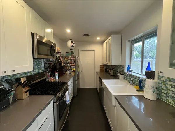 a kitchen with a sink stove and refrigerator