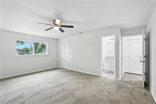 a view of a room with chandelier fan and windows