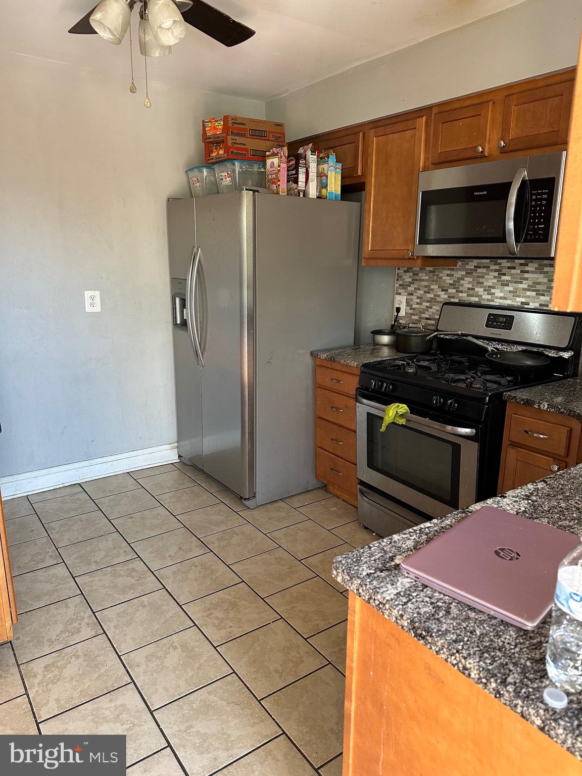 308 Sollers Point Road Dundalk, MD 21222 - Photo 5 of 22 a kitchen with stainless steel appliances granite countertop a stove a refrigerator and a microwave