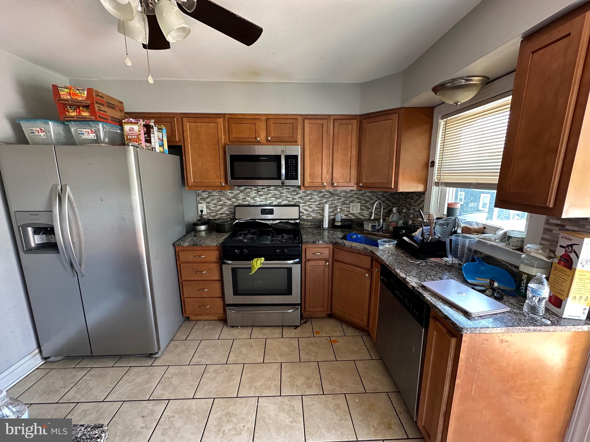 308 Sollers Point Road Dundalk, MD 21222 - Photo 6 of 22 a kitchen with stainless steel appliances granite countertop a refrigerator stove top oven a sink and dishwasher