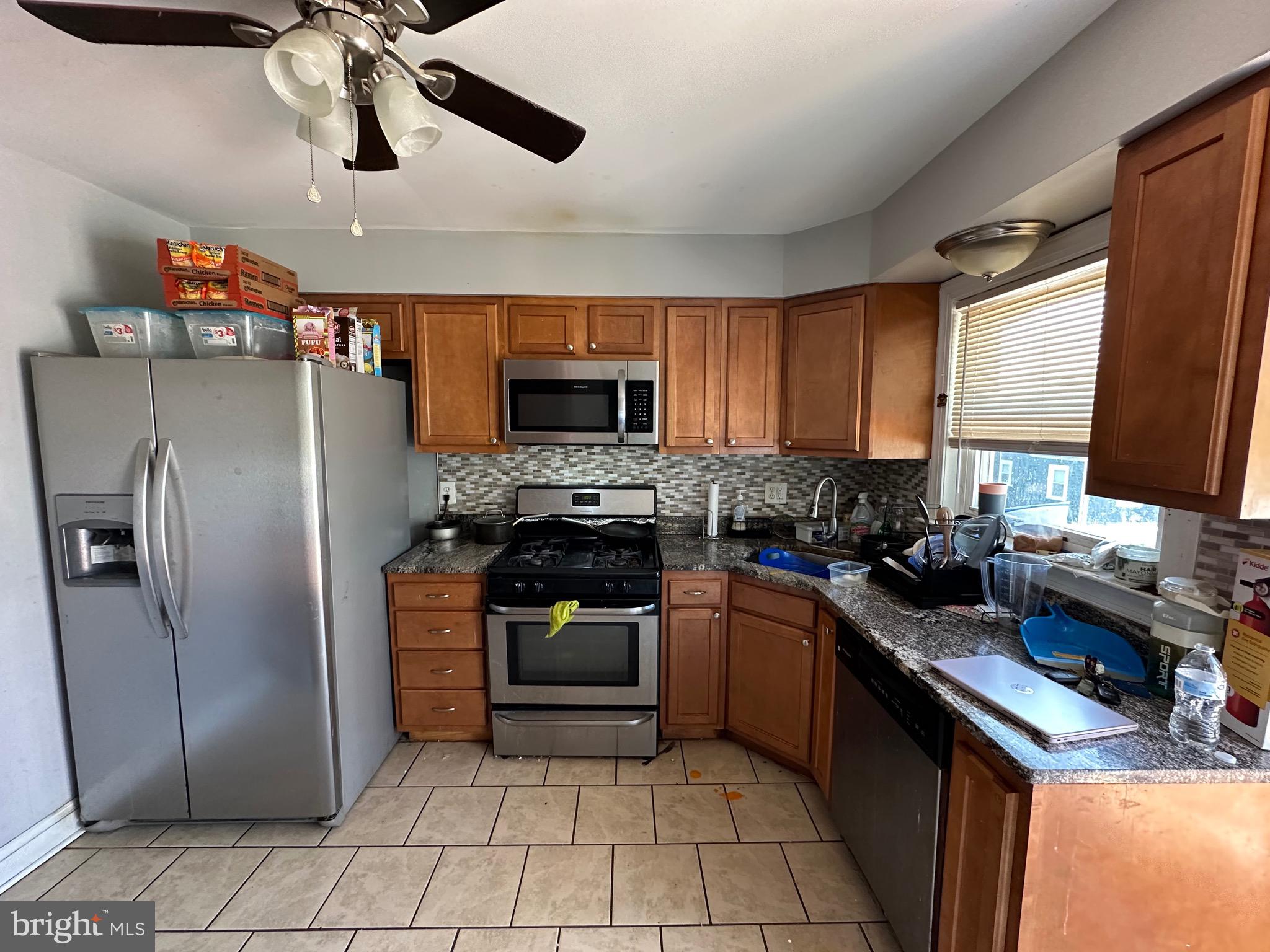 308 Sollers Point Road Dundalk, MD 21222 - Photo 7 of 22 a kitchen with stainless steel appliances granite countertop a refrigerator a sink a stove top oven and a dishwasher