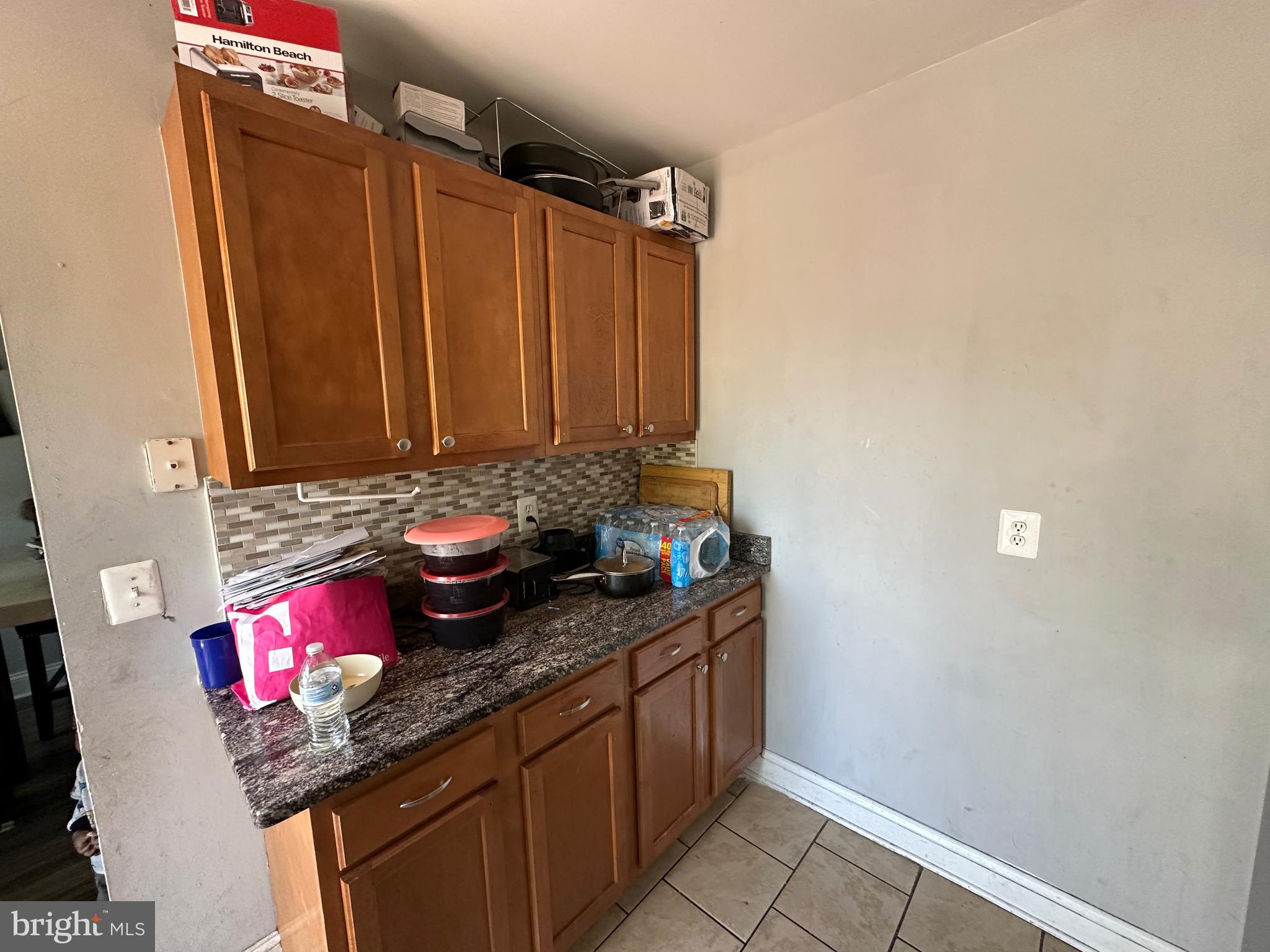 308 Sollers Point Road Dundalk, MD 21222 - Photo 8 of 22 a bathroom with a granite countertop sink and a shower curtain