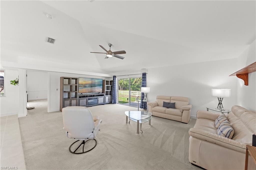 13541 Stringfellow Road Bokeelia, FL 33922 - Photo 6 of 49 a living room with furniture and a flat screen tv