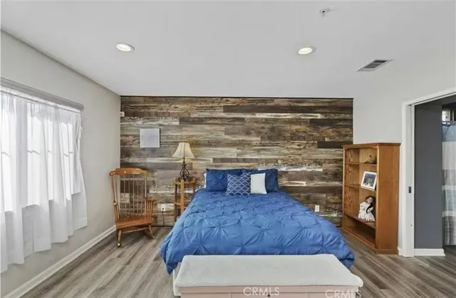 a living room with a couch and a wooden floor