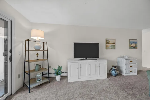 a view of a livingroom with furniture and a flat screen tv