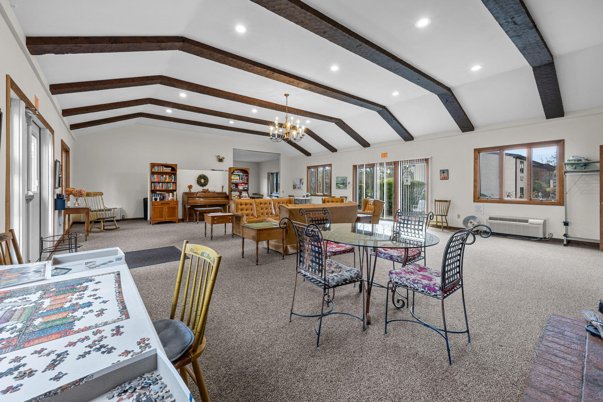 42 Old Colony Way, Unit 28 Orleans, MA 02653 - Photo 23 of 31 a living room with lots of furniture and a chandelier