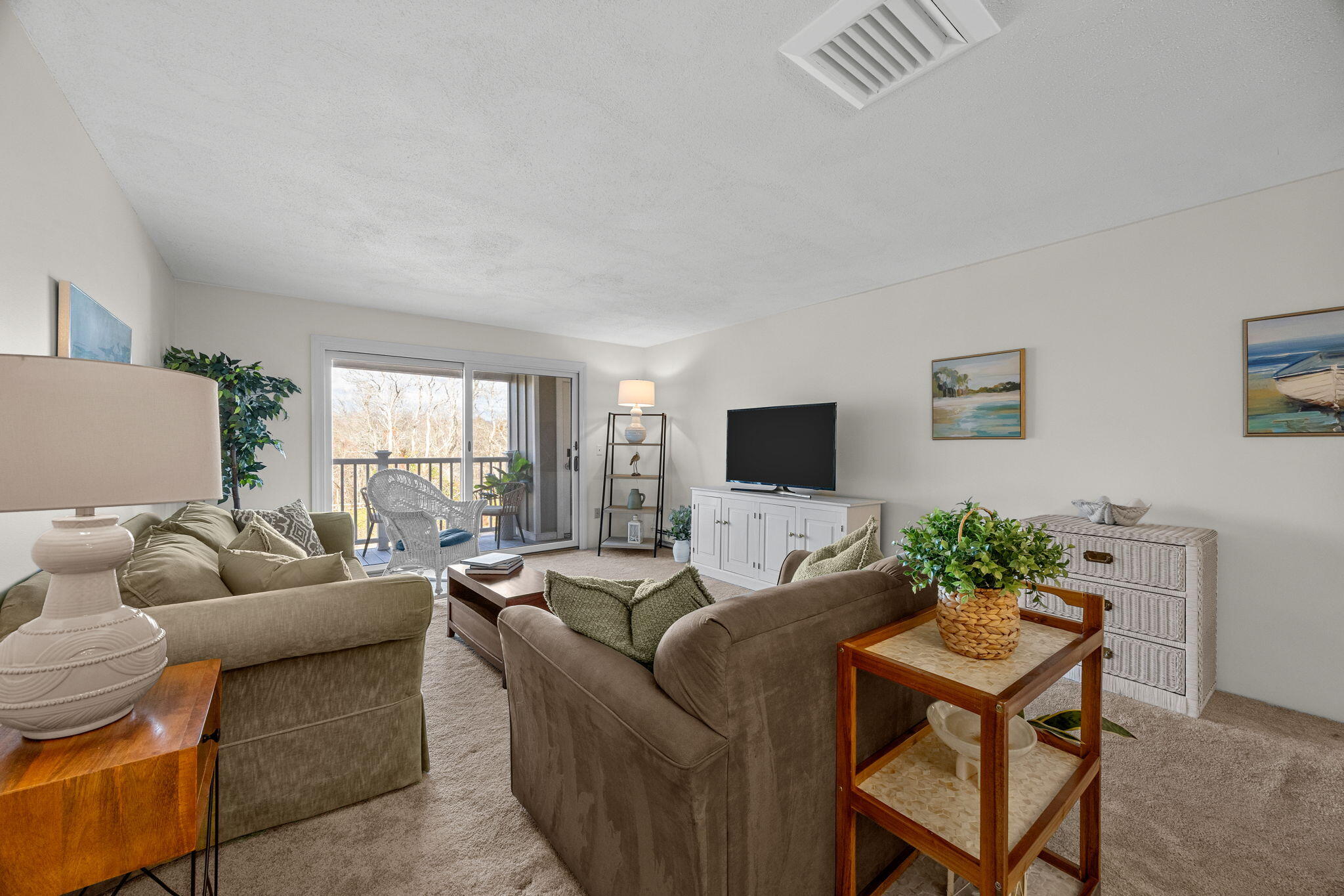 42 Old Colony Way, Unit 28 Orleans, MA 02653 - Photo 9 of 31 a living room with furniture and a flat screen tv
