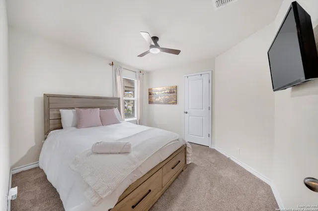 a bedroom with a bed and a flat screen tv