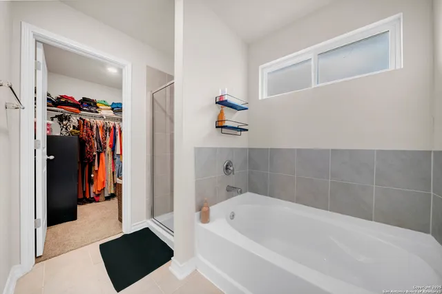 a bathroom with a bathtub and a shower