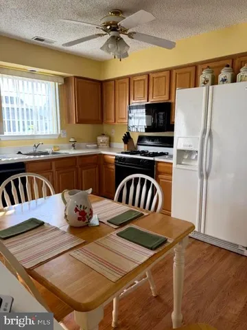 a kitchen with a stove a refrigerator and a dining table